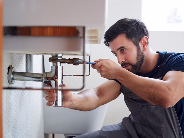 Plumber repairing a bathroom fixture